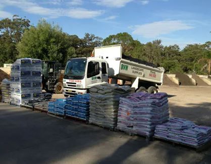A Dump Truck Is Parked Next to A Pile of Bags — BVN Landscape & Steel Supplies in St Georges Basin, NSW