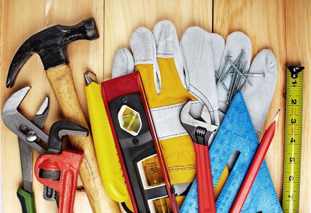 A Bunch of Tools Are Sitting on A Wooden Table — BVN Landscape & Steel Supplies in St Georges Basin, NSW