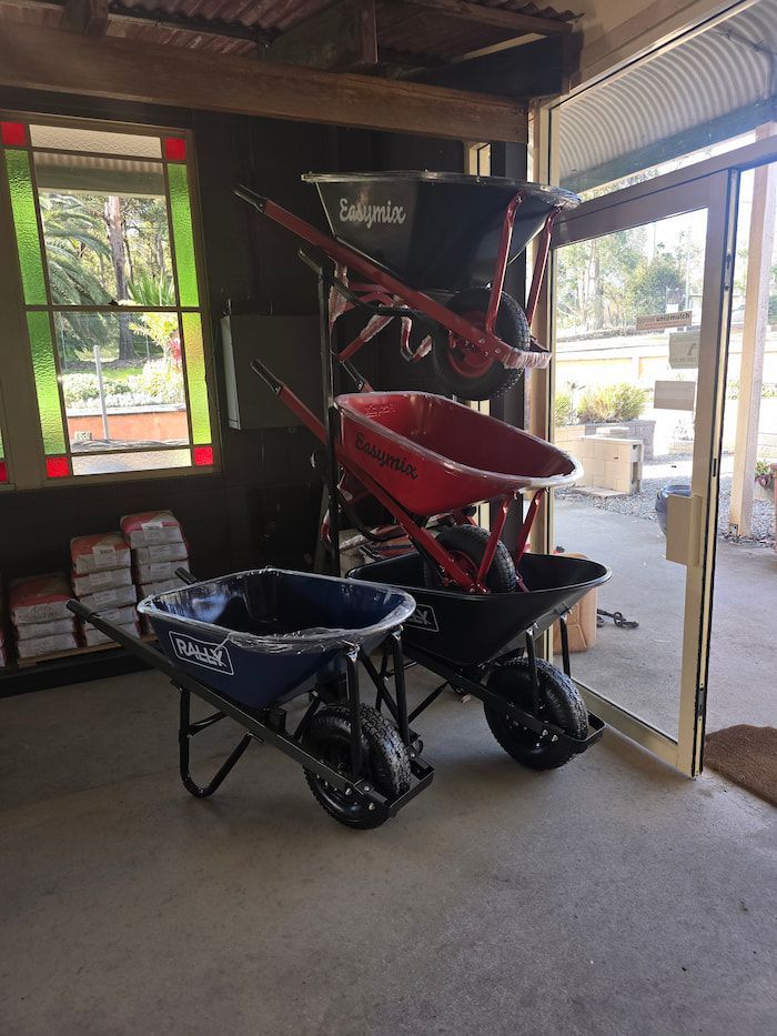 Two Wheelbarrows Are Sitting Next to Each Other in A Room — BVN Landscape & Steel Supplies in St Georges Basin, NSW