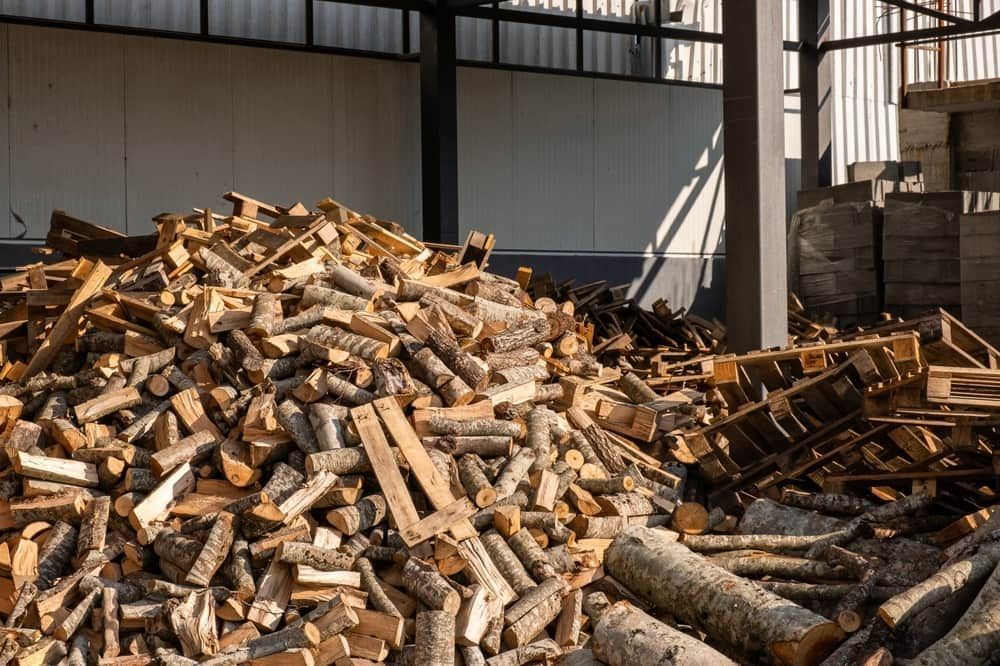 Piles of Chopped Firewood Stacked in an Outdoor Yard — BVN Landscape & Steel Supplies in Callala Beach, NSW