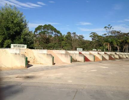 A Row of Concrete Blocks in A Parking Lot with Trees in The Background — BVN Landscape & Steel Supplies in Berry, NSW