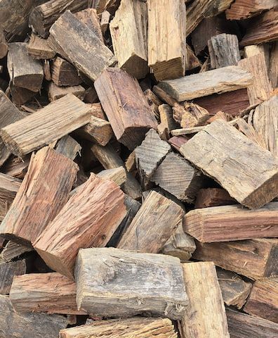 Pile of Weathered Firewood, Varying Colors of Brown and Gray — BVN Landscape & Steel Supplies in St Georges Basin, NSW