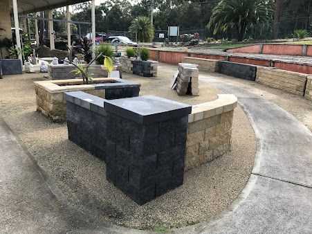 A Brick Wall with A Bench in The Middle of It — BVN Landscape & Steel Supplies in Vincentia, NSW
