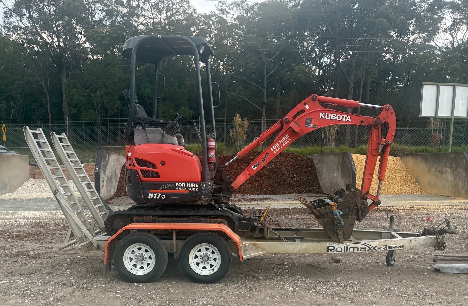 Red Mini Excavator Digging In the Sand — BVN Landscape & Steel Supplies in St Georges Basin, NSW