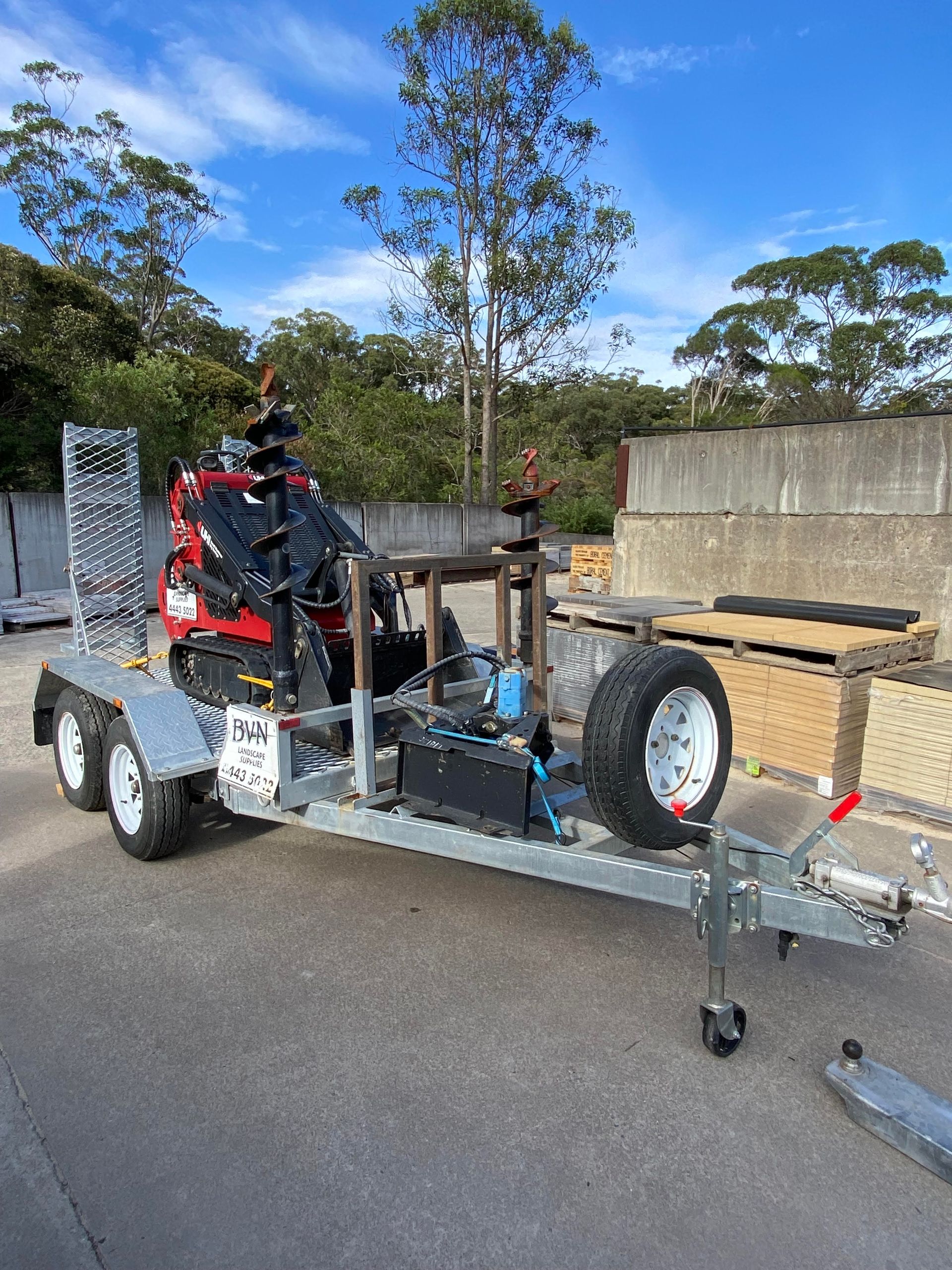 Mini Excavator With Auger on a Trailer, Parked Outdoors — BVN Landscape & Steel Supplies in St Georges Basin, NSW
