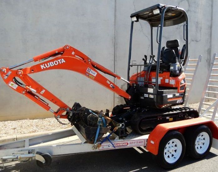 Orange Kubota Mini Excavator on a Trailer — BVN Landscape & Steel Supplies in St Georges Basin, NSW