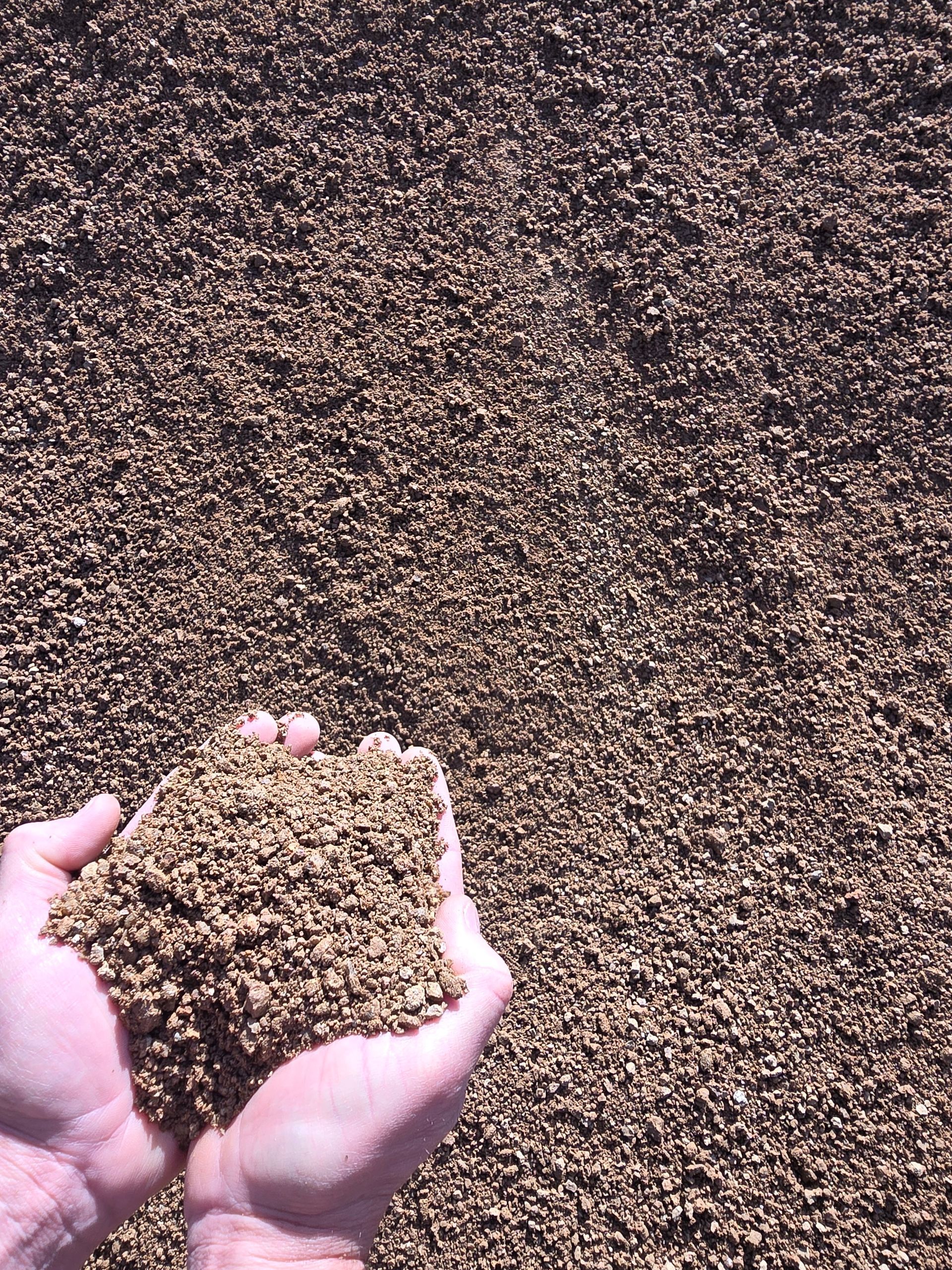 Hands Cupped Holding a Handful of Small, Brown Gravel — BVN Landscape & Steel Supplies in St Georges Basin, NSW