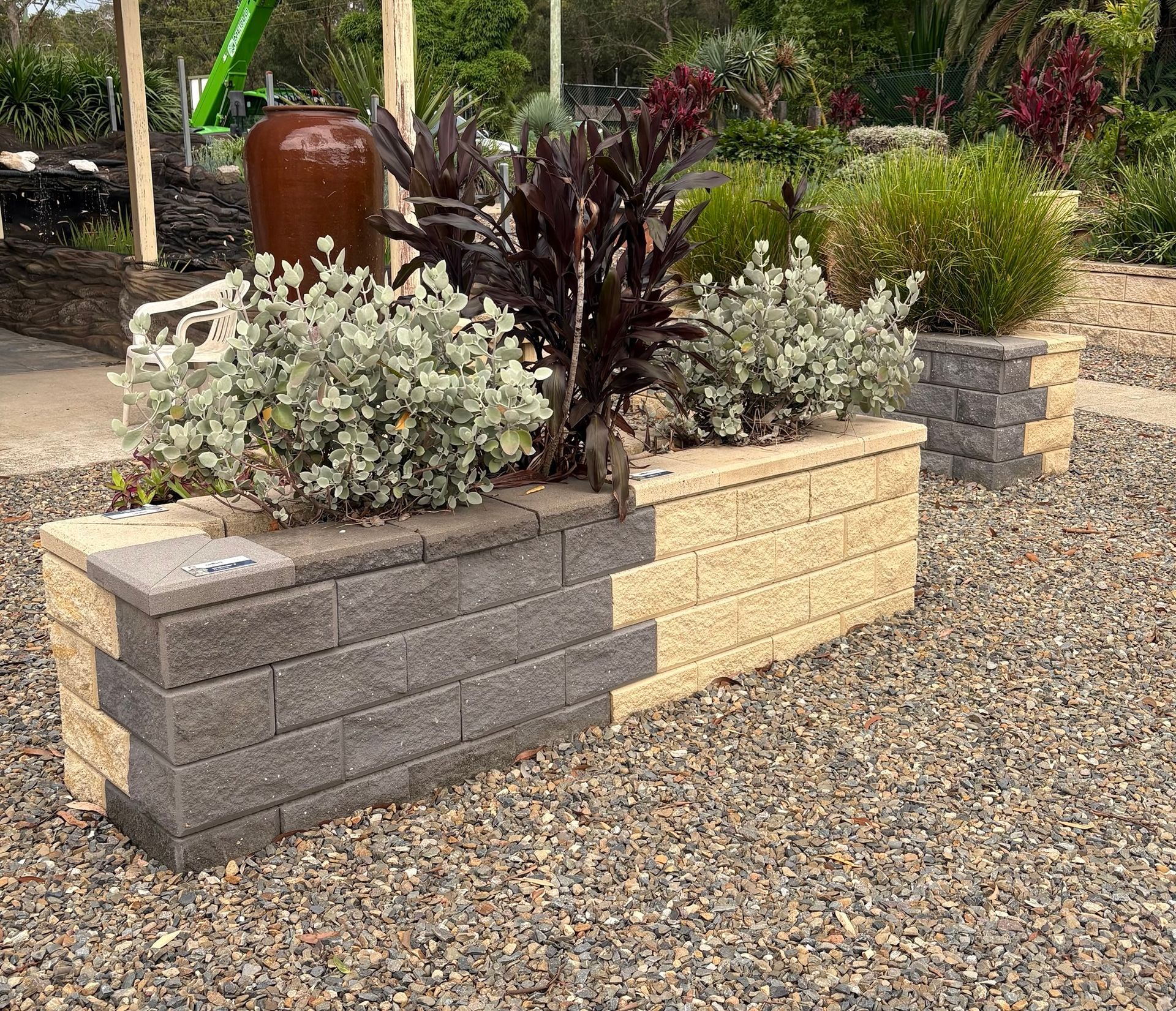 A Row of Concrete Blocks Surrounded By Plants— BVN Landscape & Steel Supplies in St Georges Basin, NSW