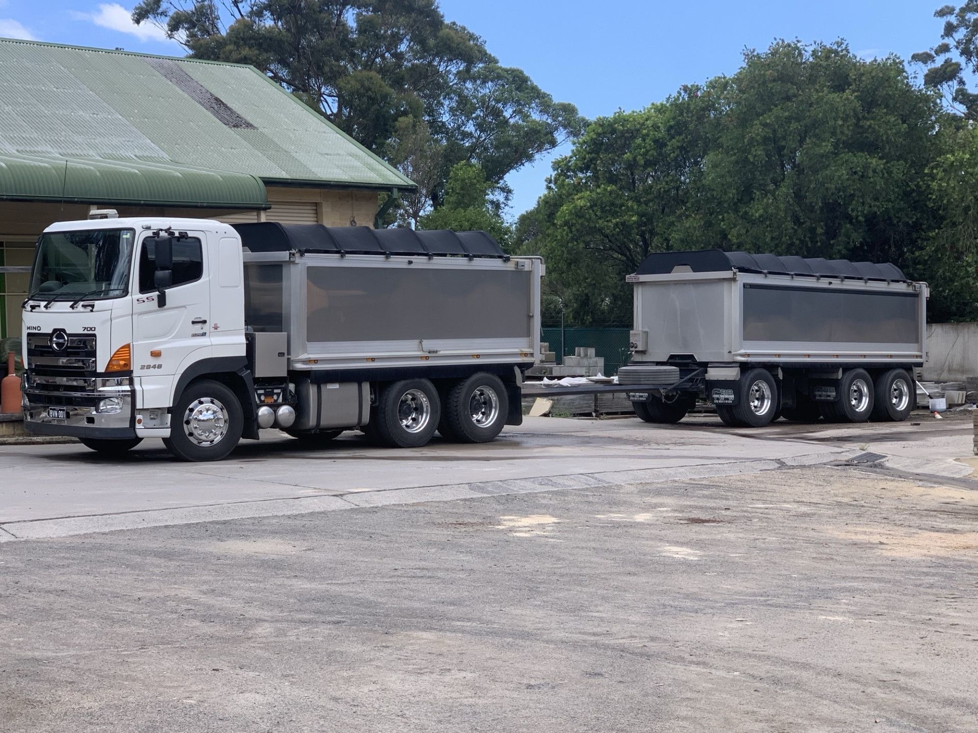 White Dump Truck With Trailer Parked in Front of a Building — BVN Landscape & Steel Supplies in St Georges Basin, NSW
