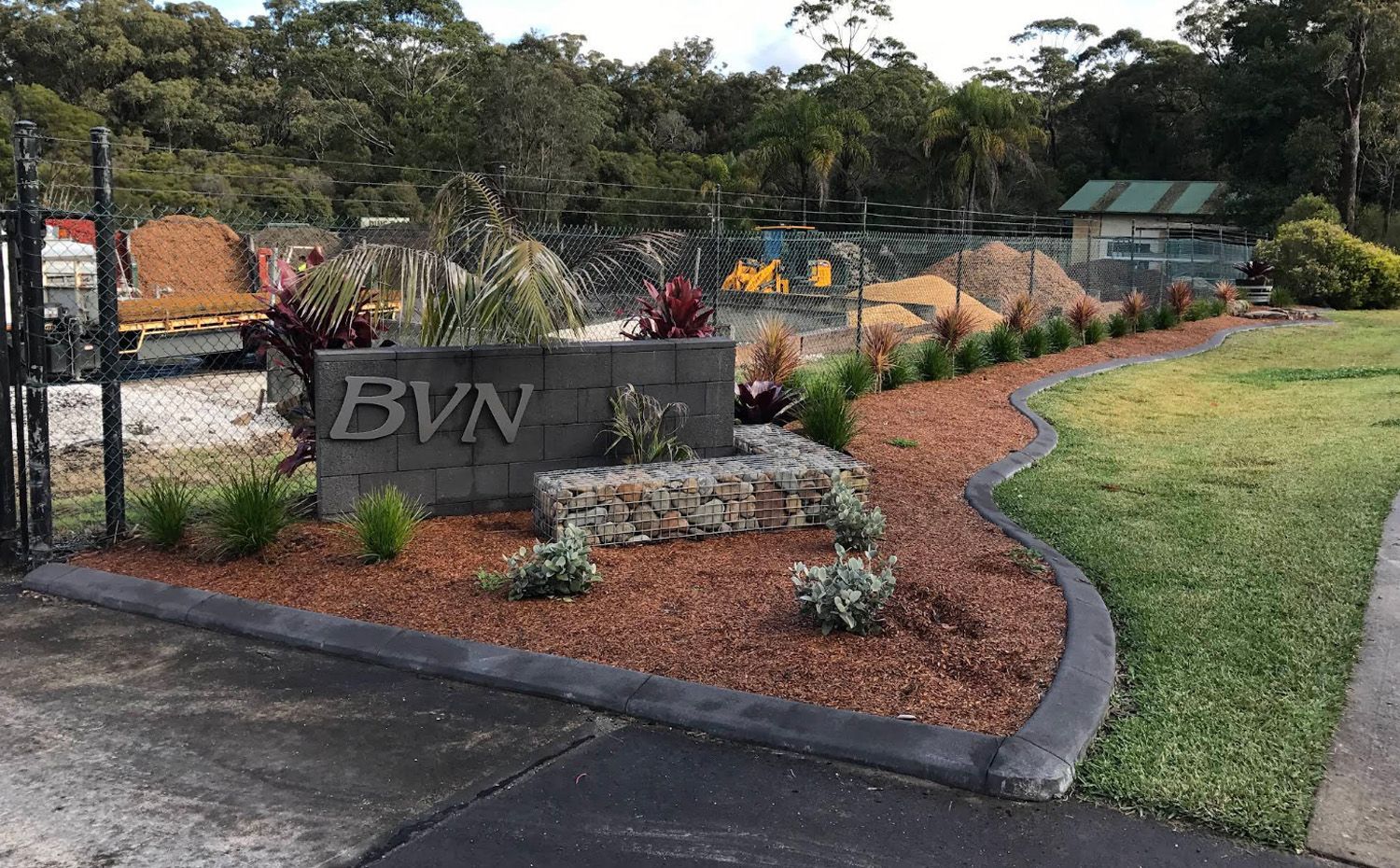 A Landscaped Entrance Sign Reading 