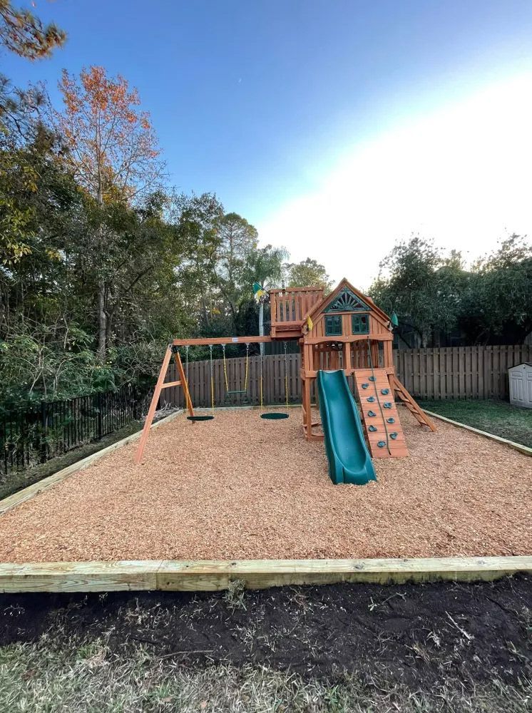 A wooden playground set in backyard