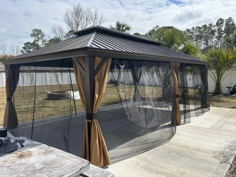 Metal-roofed gazebo with mesh curtains