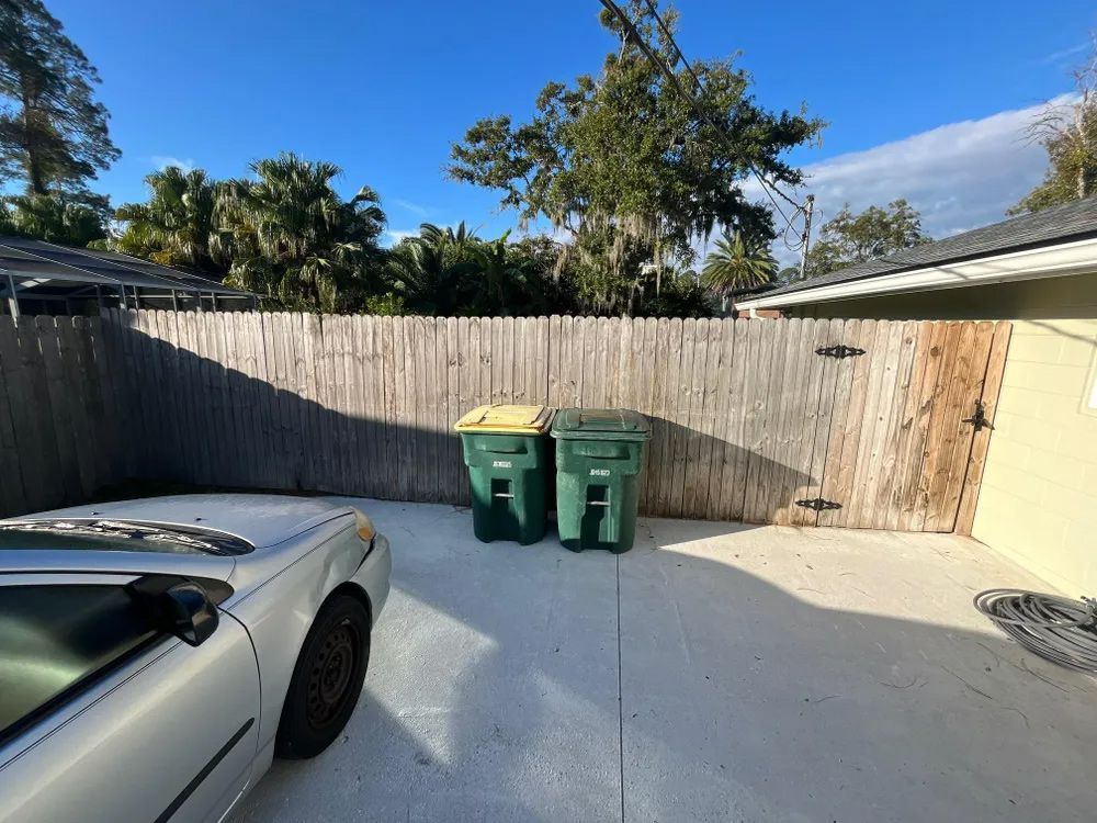 Concrete driveway with wooden fence