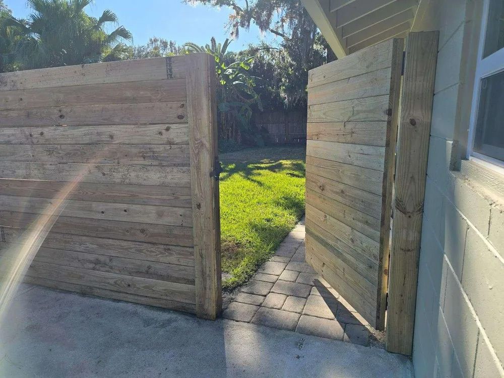 A partially open horizontal wood fence gate