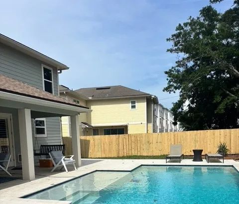 A swimming pool and fence in backyard