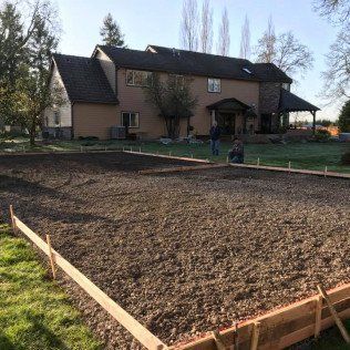 A large house with a lot of dirt in front of it.