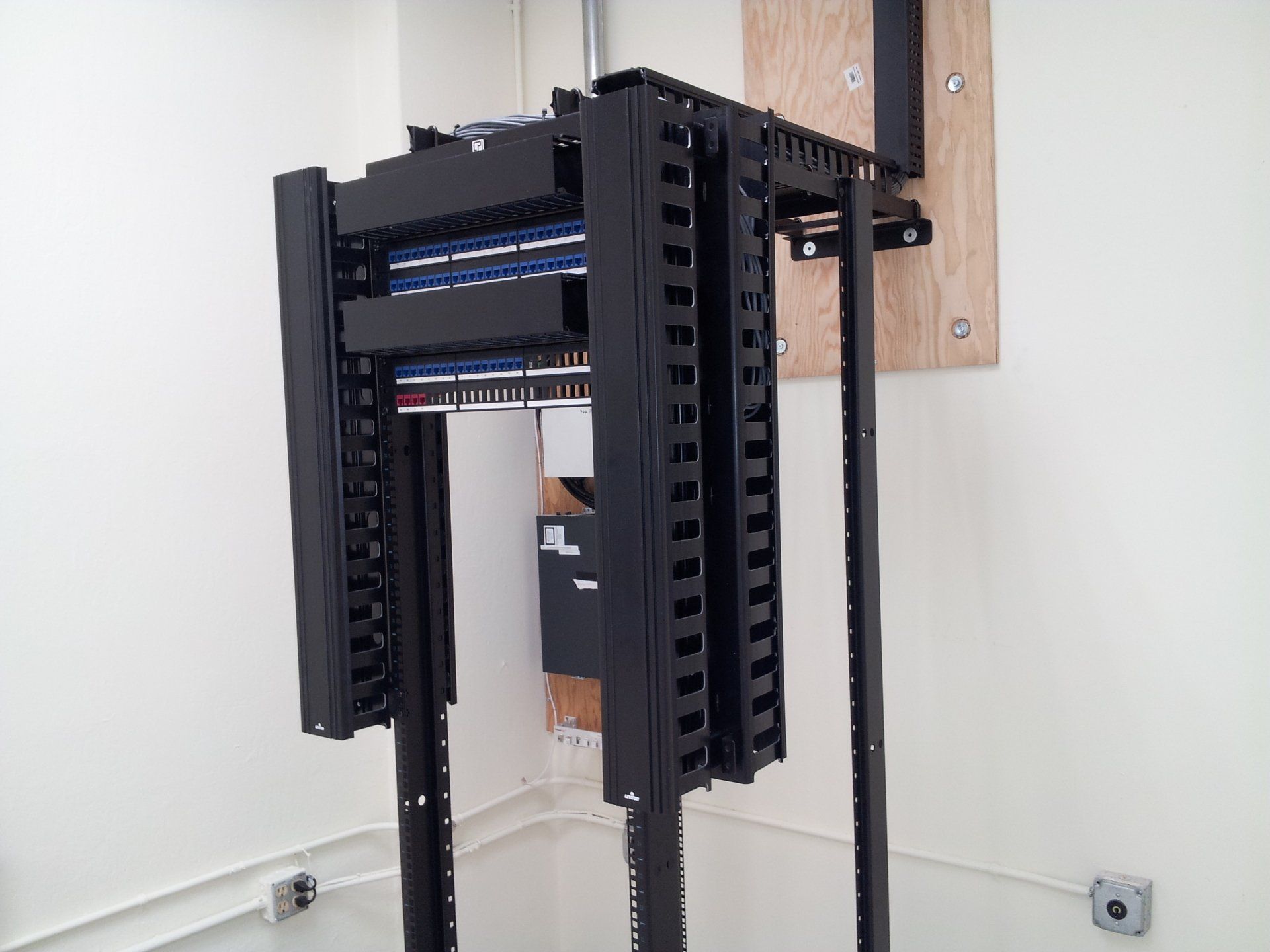 A server rack with a bunch of wires coming out of it