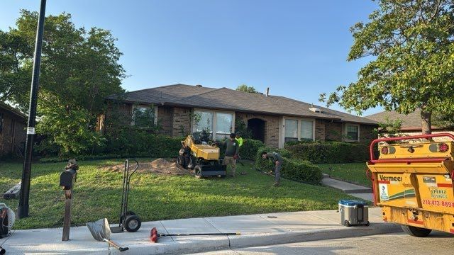 A yellow truck is parked in front of a house.