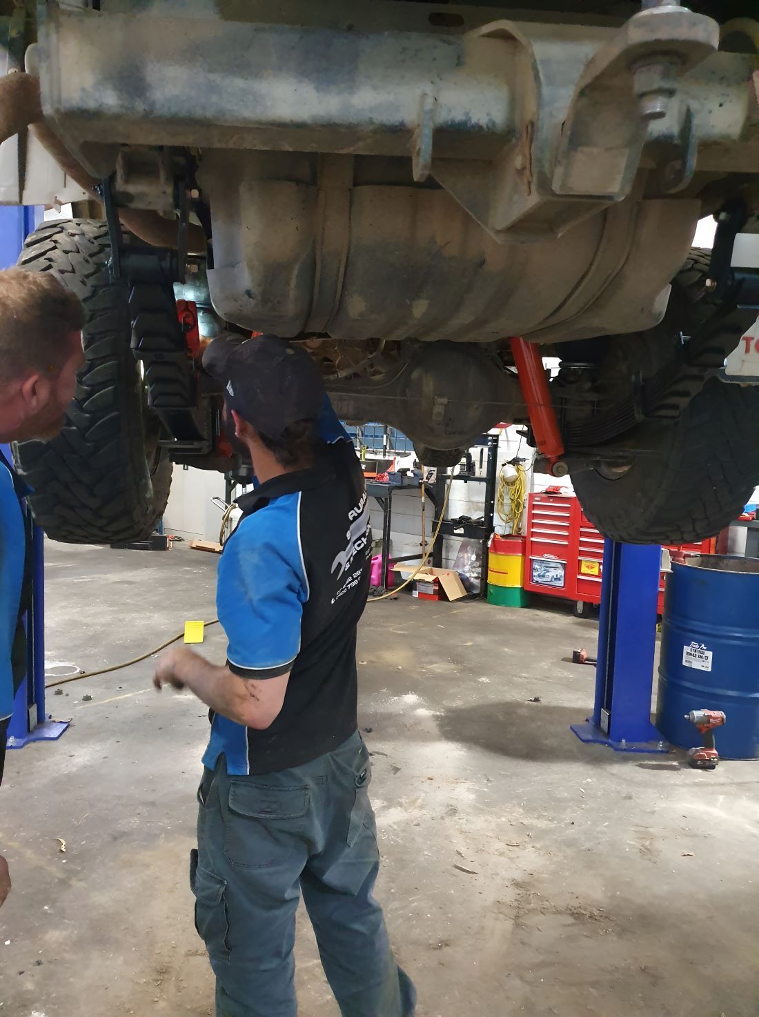 A Truck is Being Repaired by Two Person — SMK Rural & Mechanical Pty Ltd in Rockhampton City, QLD