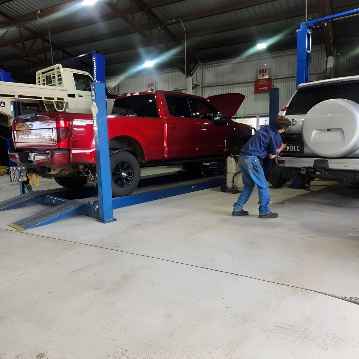A Man is Working on a Garage — SMK Rural & Mechanical Pty Ltd in Rockhampton City, QLD