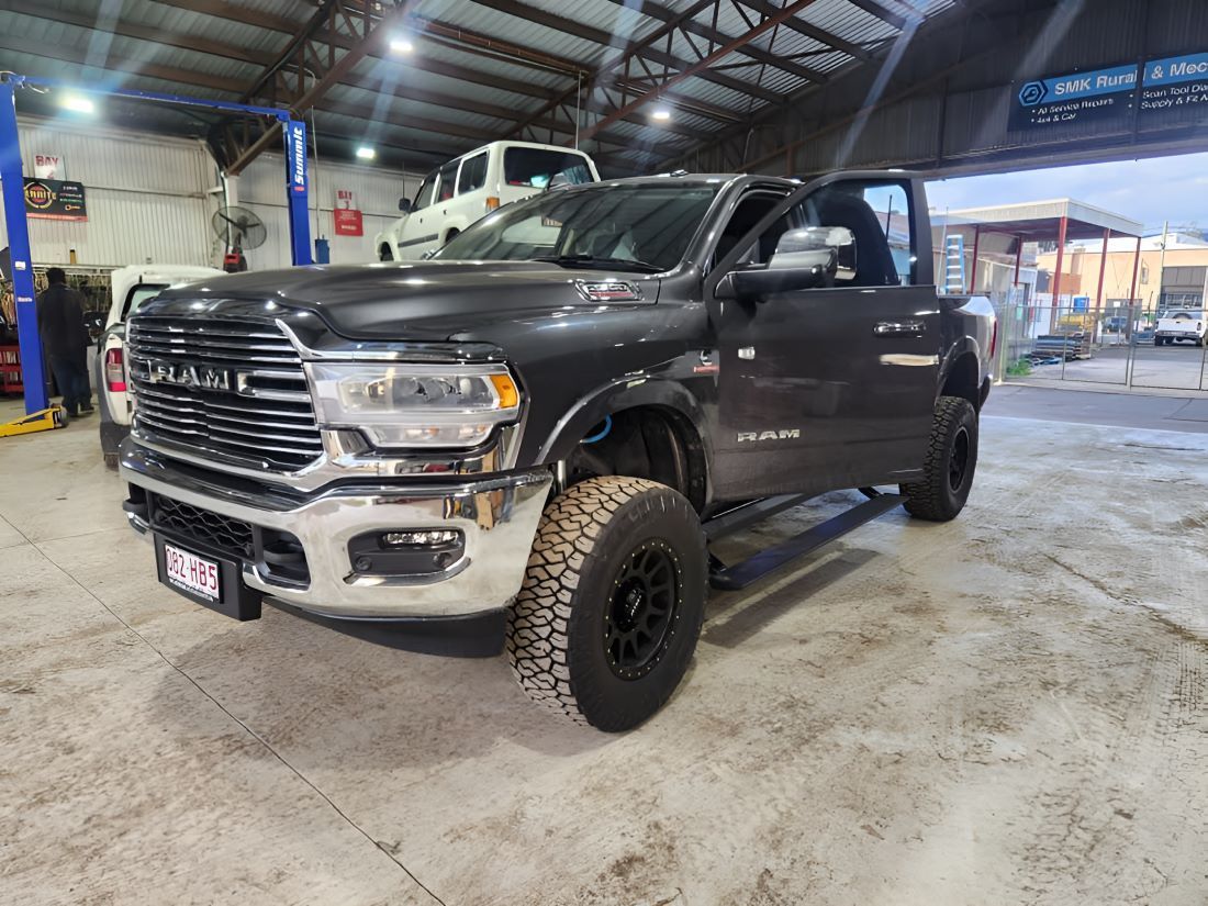 A Black Dodge Ram Truck is Parked in a Garage — SMK Rural & Mechanical Pty Ltd in Rockhampton City, QLD