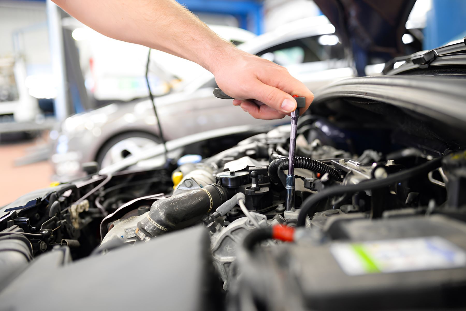 A Man is Working on the Engine of a Car — SMK Rural & Mechanical Pty Ltd in Rockhampton City, QLD