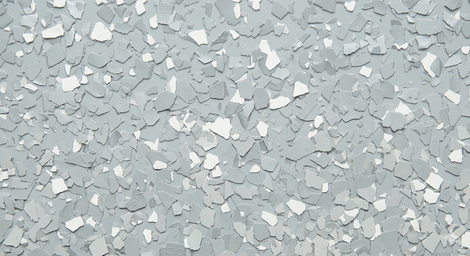 Light gray speckled concrete surface with scattered white paint chips