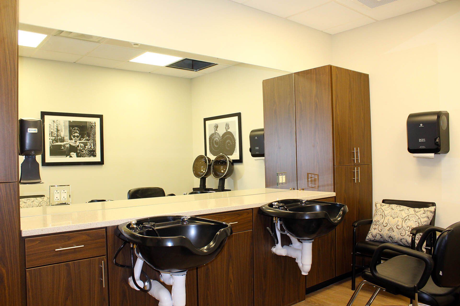 A bathroom with two sinks and a large mirror.