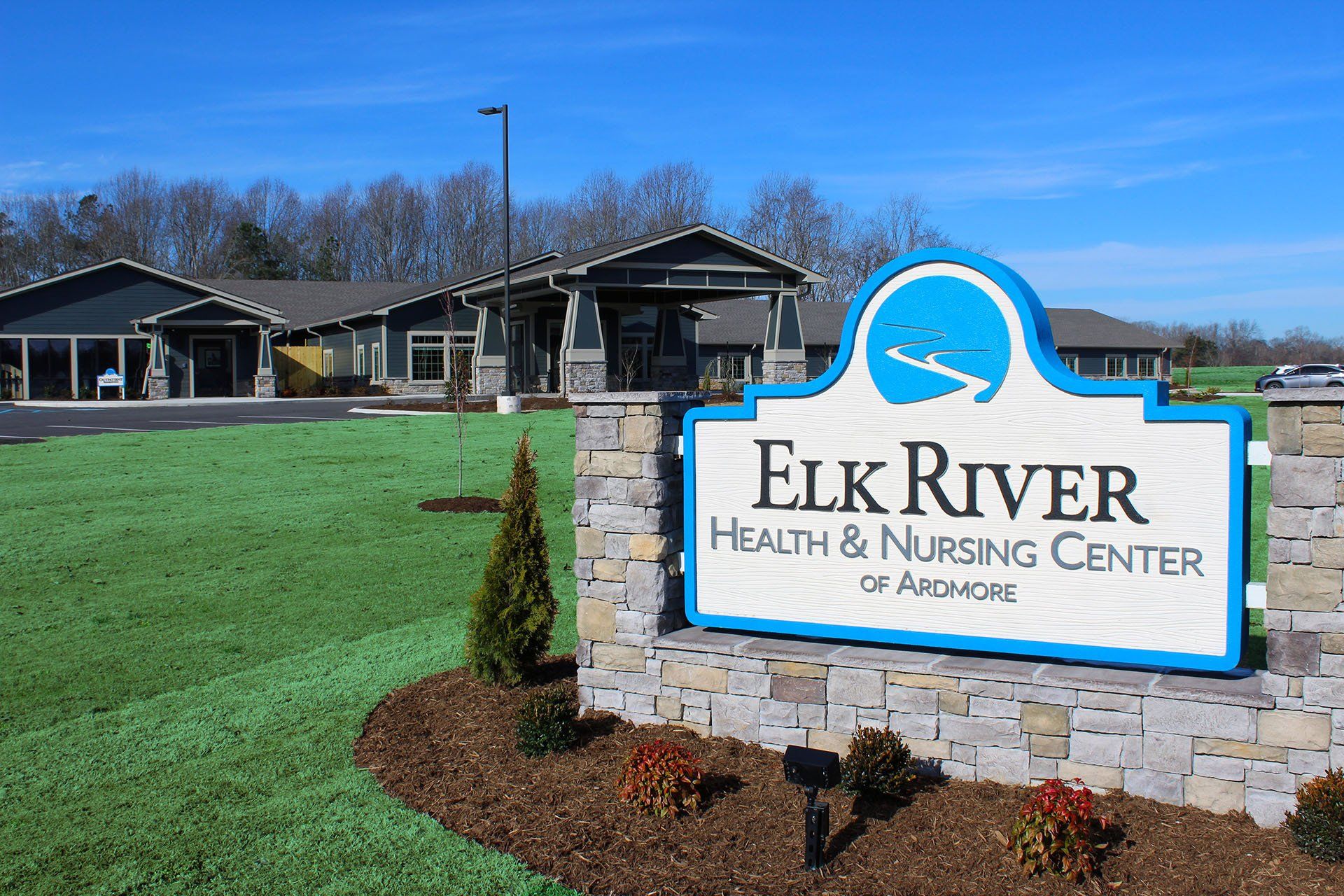 A sign for elk river health and nursing center is in front of a building.