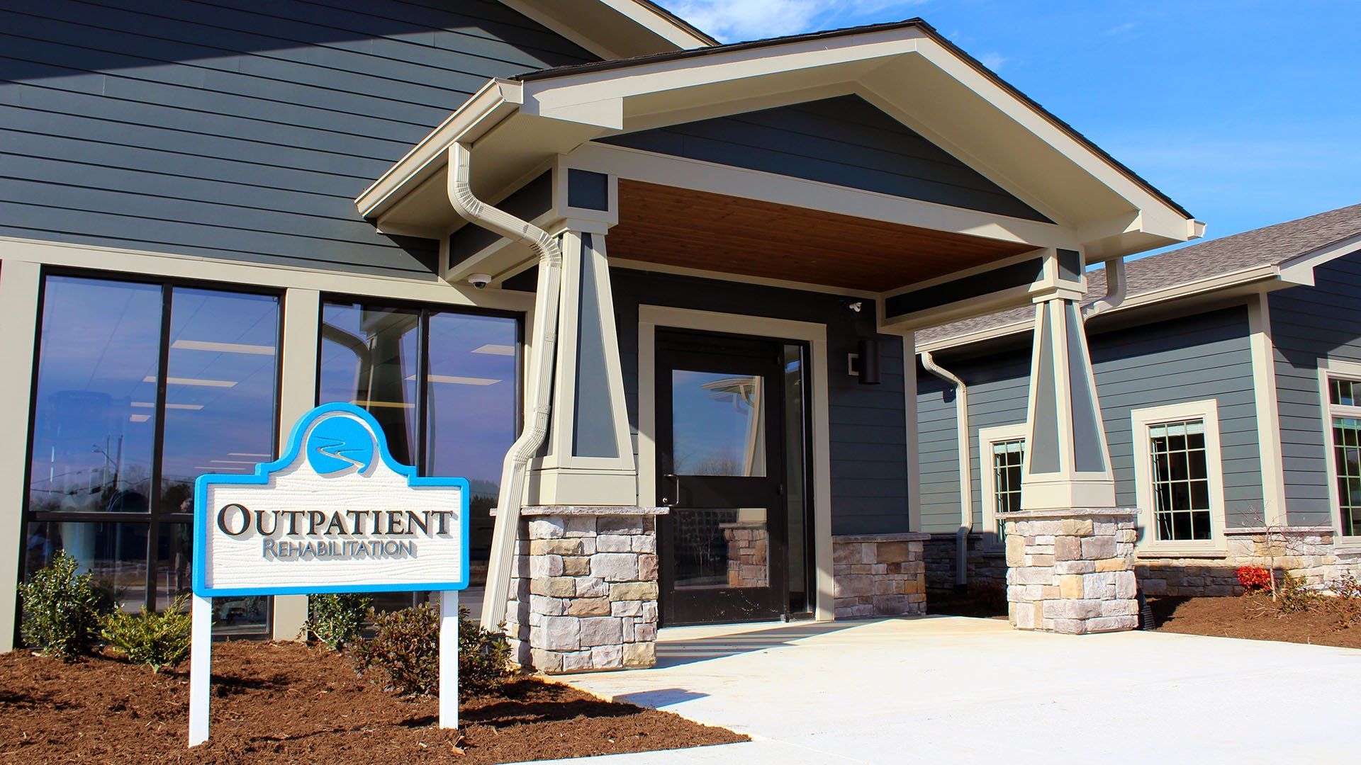 A large building with a sign that says outpatient on it.