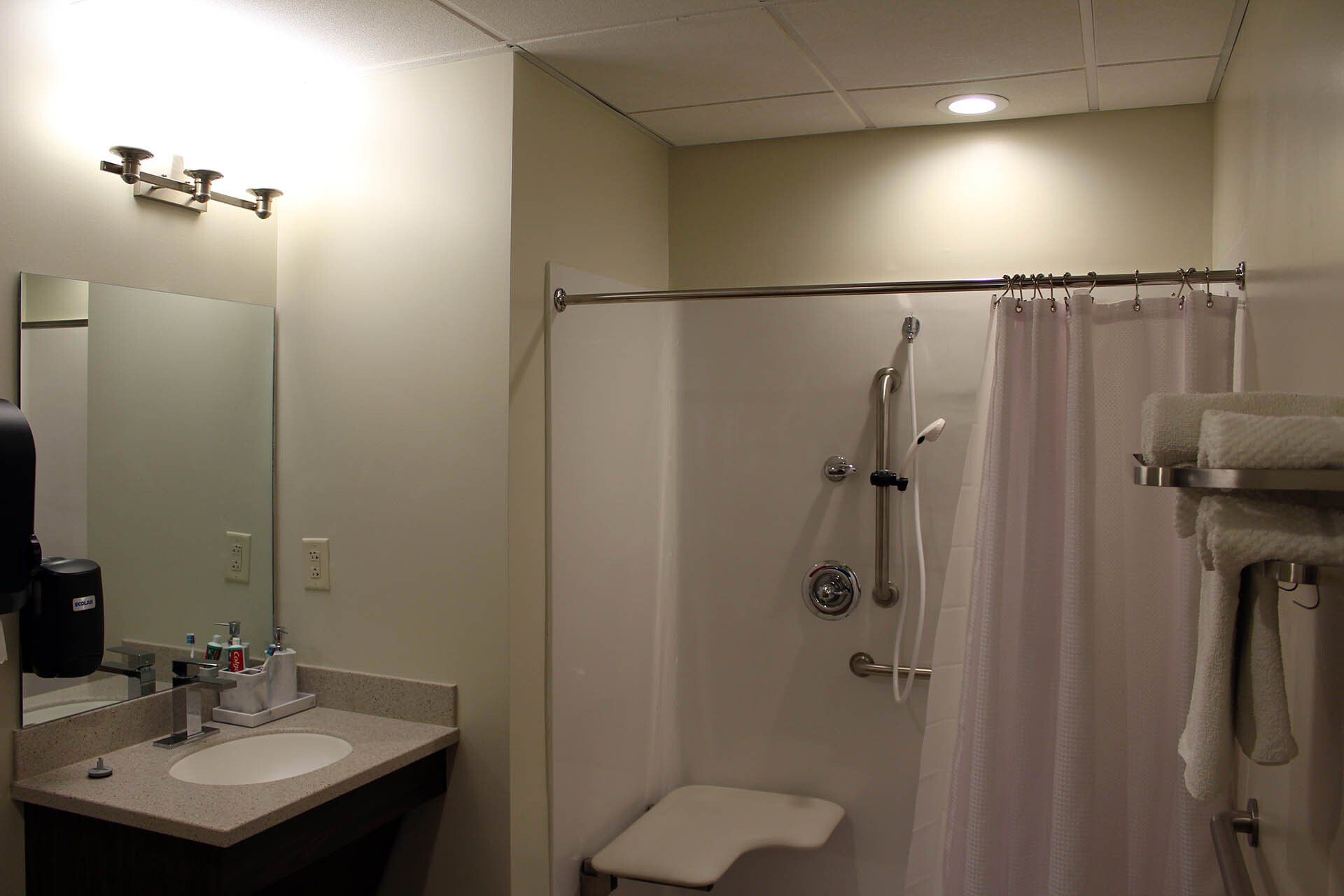A bathroom with a sink and a shower curtain