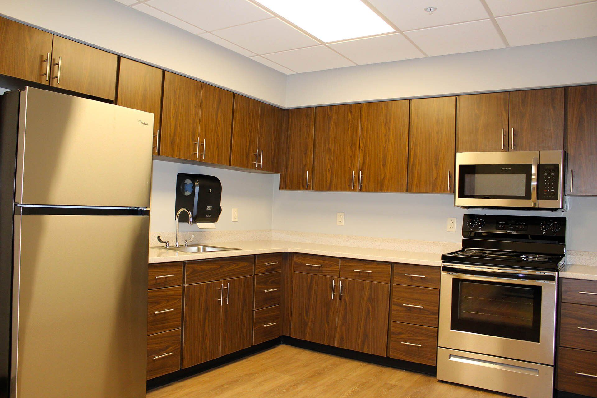 A kitchen with stainless steel appliances and wooden cabinets