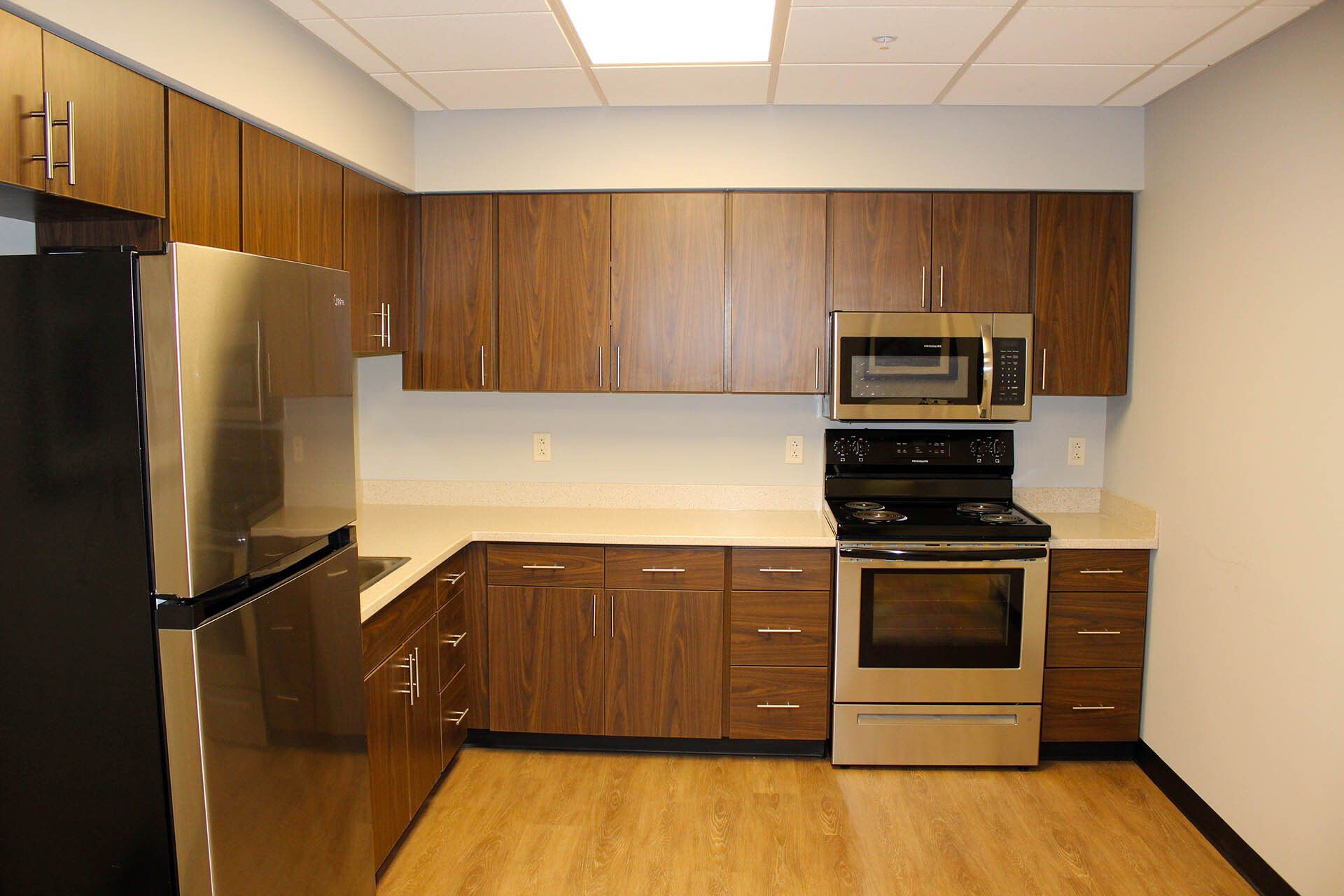 A kitchen with stainless steel appliances and wooden cabinets