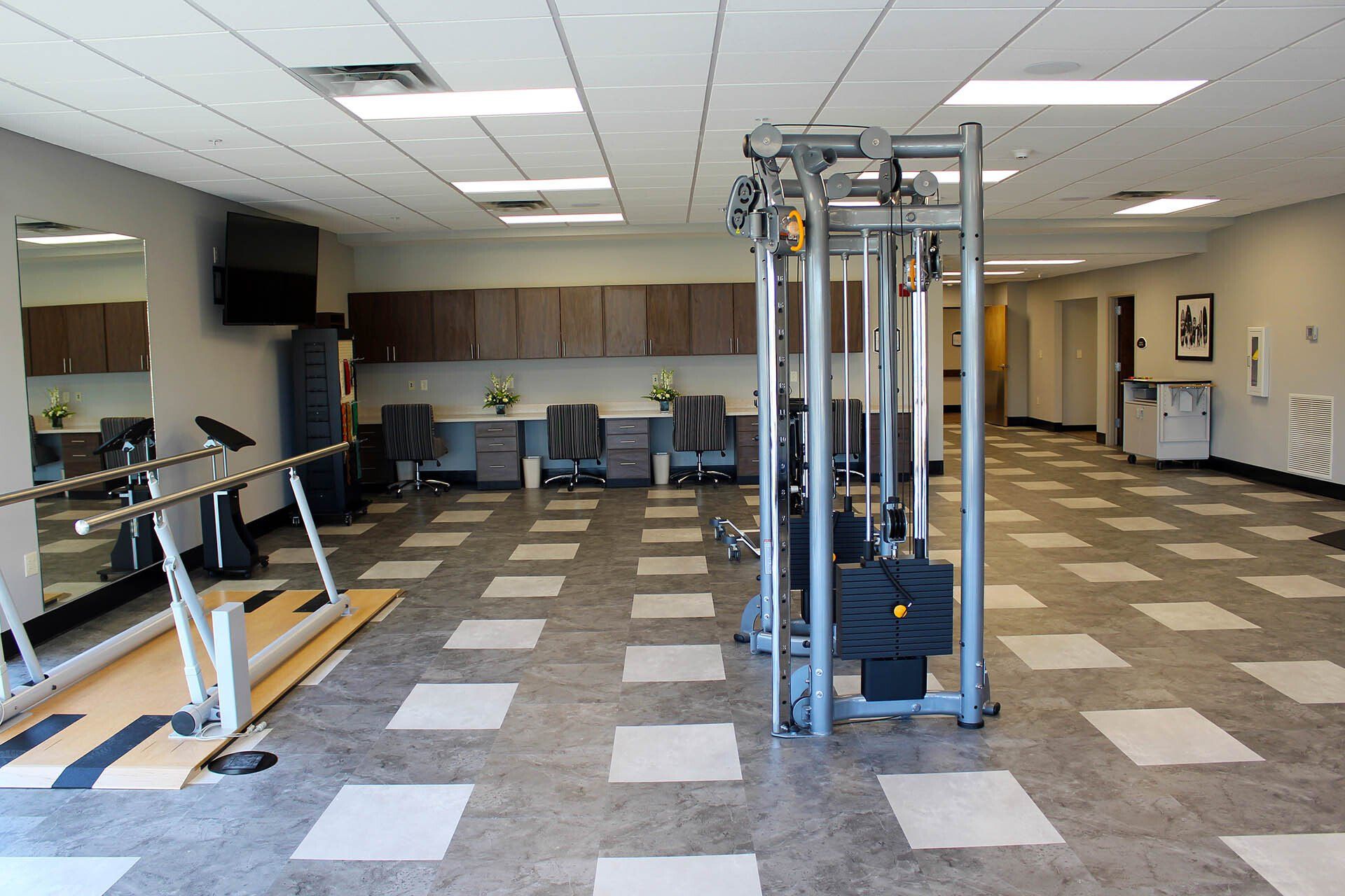 A large room with a lot of exercise equipment in it