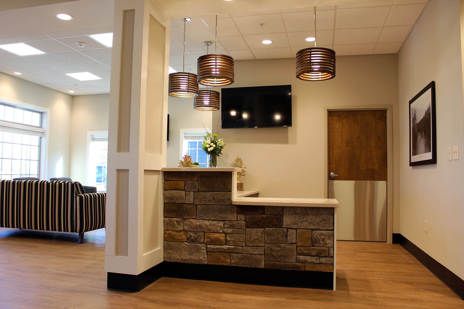 There is a stone counter in the middle of the room.