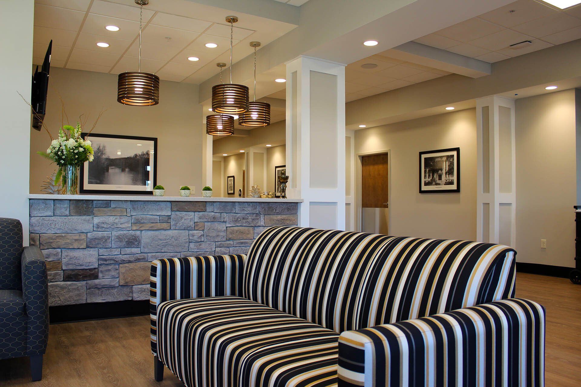 A black and white striped couch is in a living room.