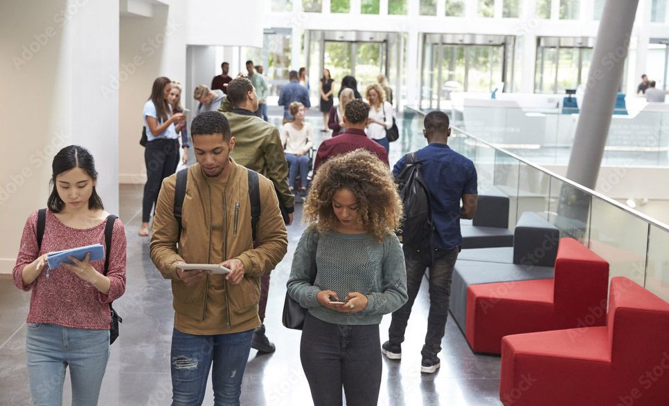 A group of students are walking down a hallway.