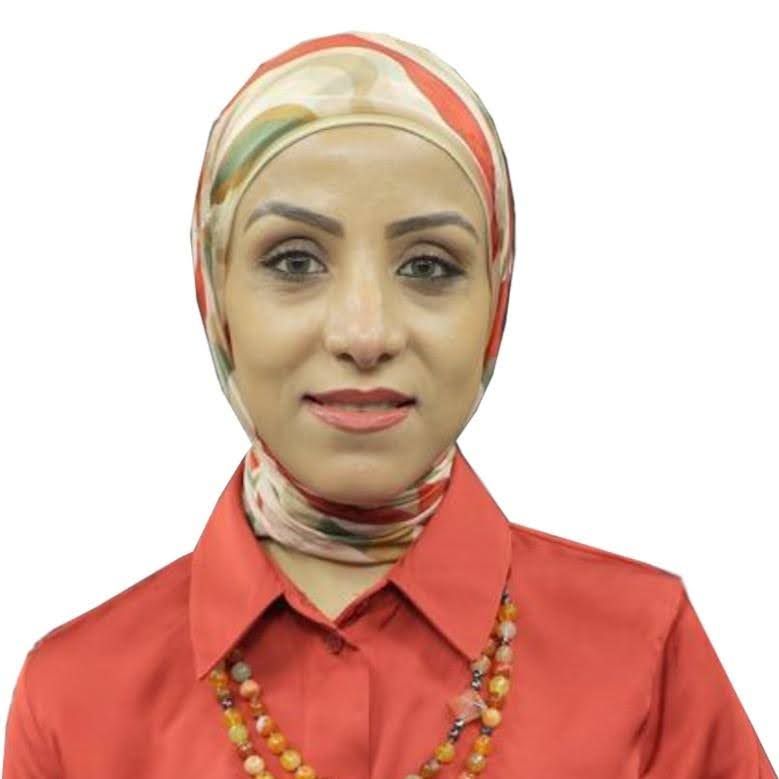 A woman wearing a scarf and a red shirt