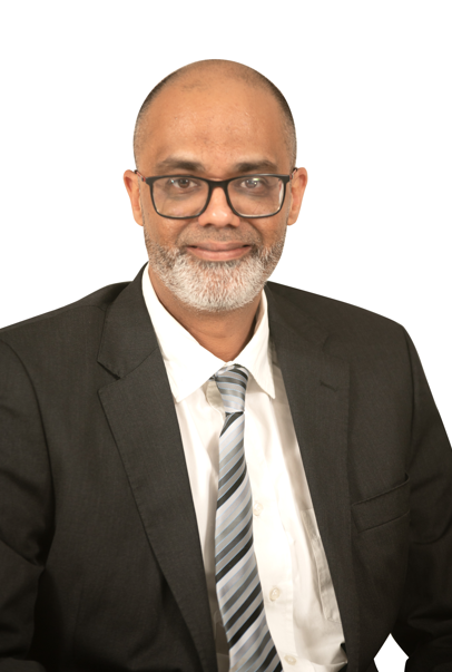 A man in a suit and tie is smiling for the camera