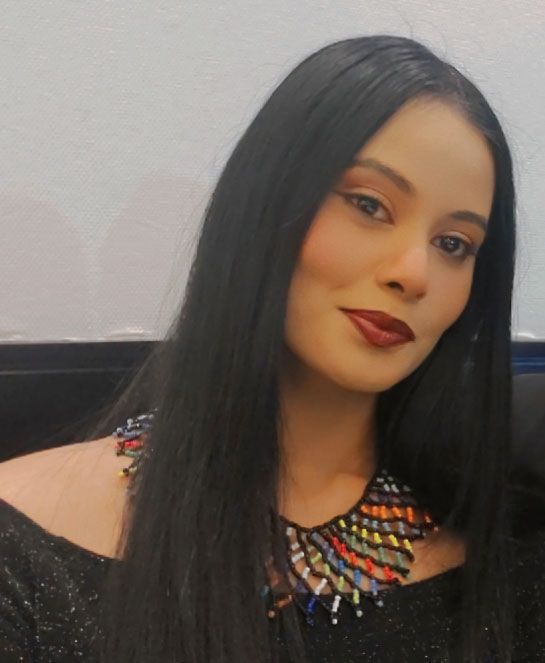 A woman wearing a black jacket and a zebra print shirt