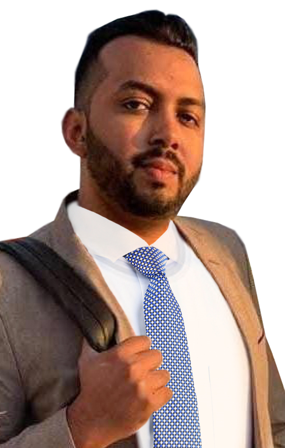 A man in a suit and tie is holding a backpack.