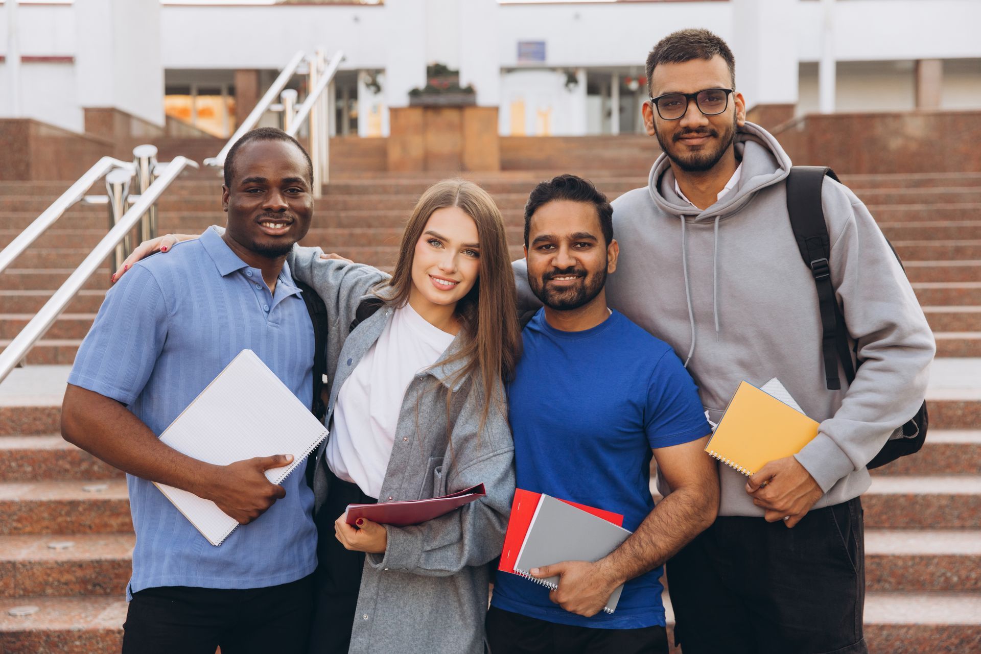 A group of students are posing for a picture on a set of stairs.