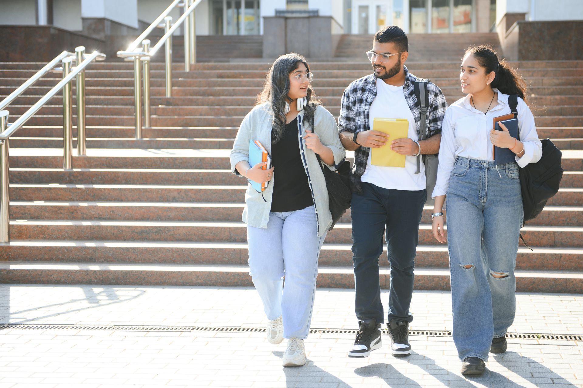 A group of students are walking down a set of stairs.