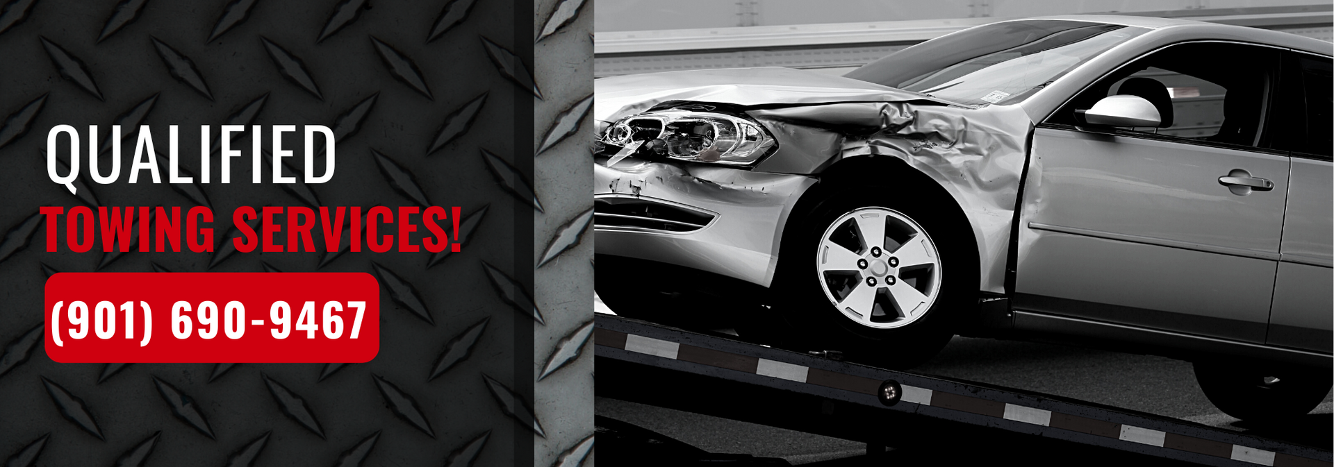 A damaged silver car on a tow truck bed with text reading