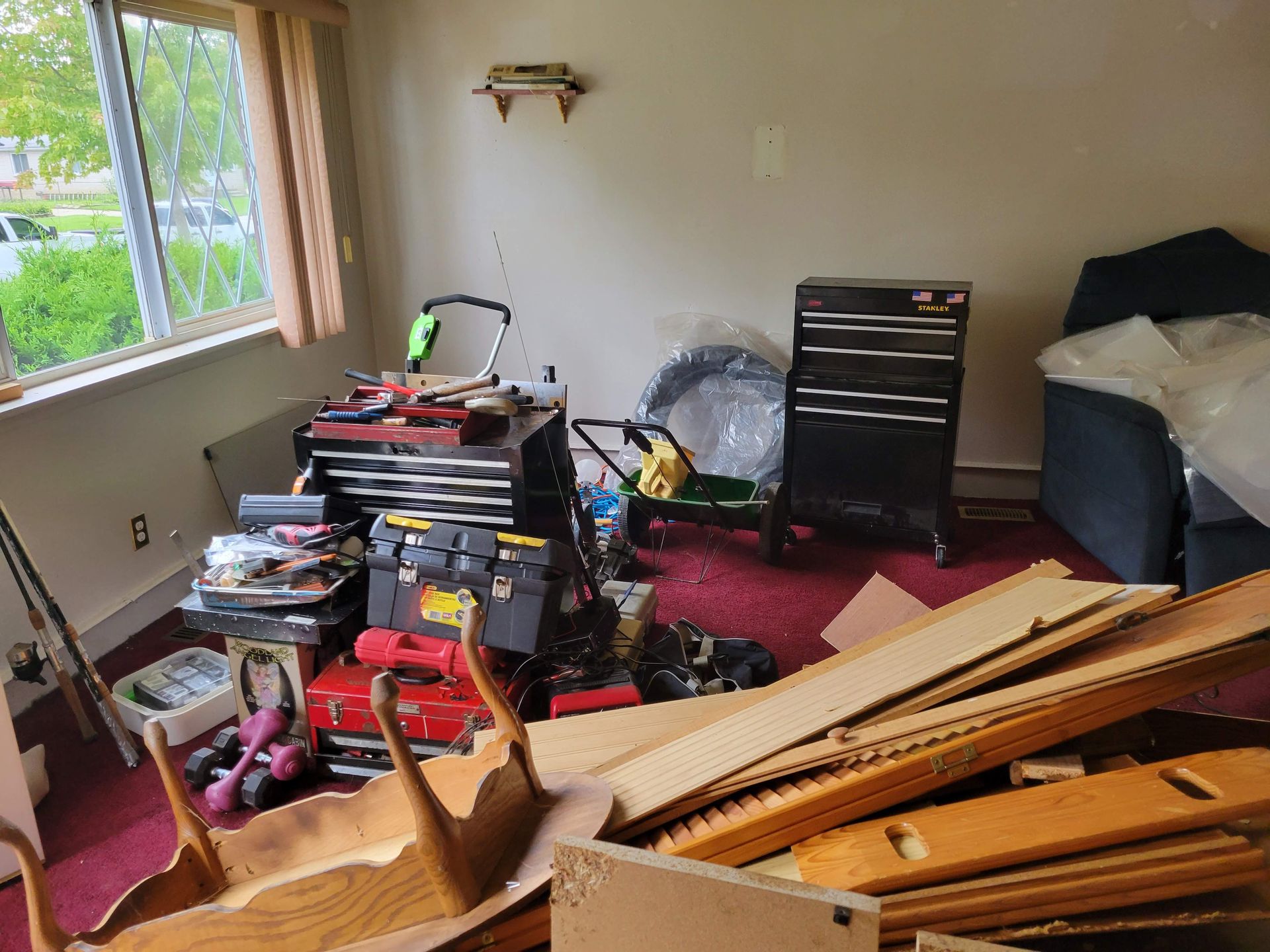 A living room filled with lots of junk and tools.