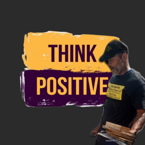 A man is standing in front of a sign that says think positive