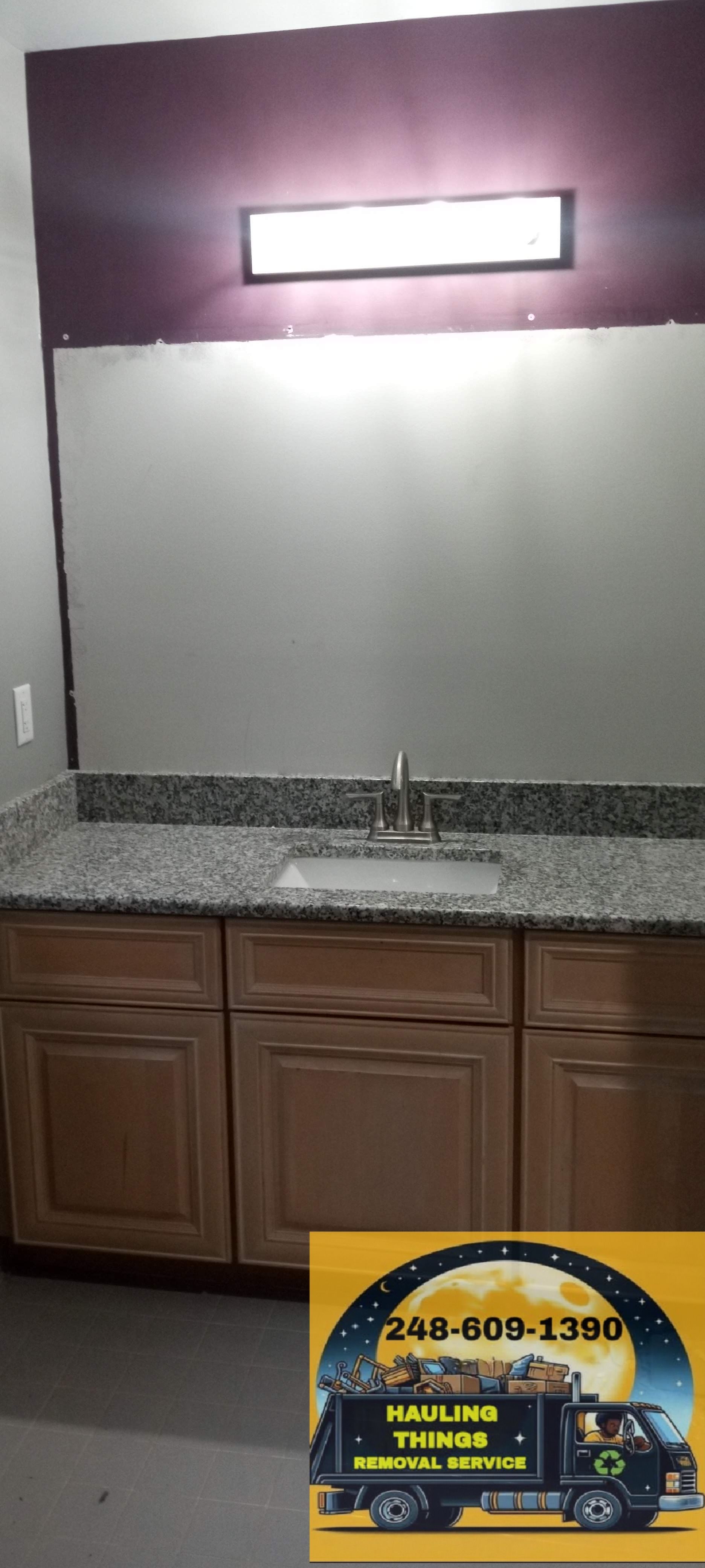 A bathroom with a sink, cabinets and a mirror.