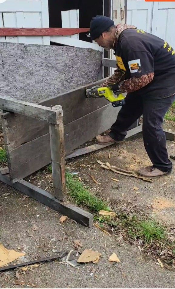 A man is using a drill to cut a piece of wood.