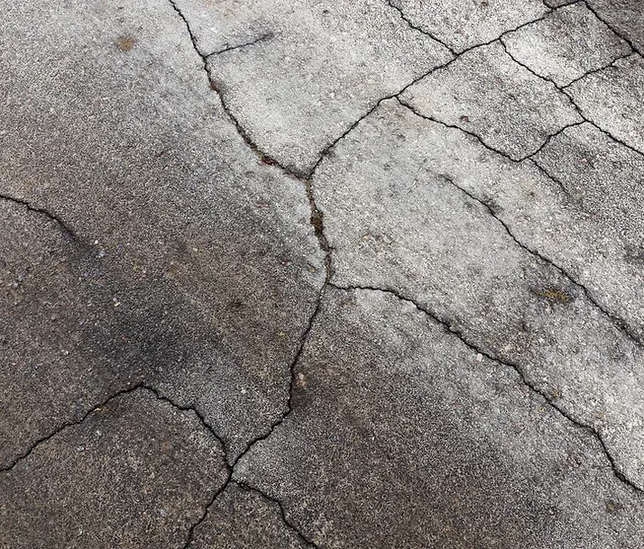 A close up of a cracked concrete floor.