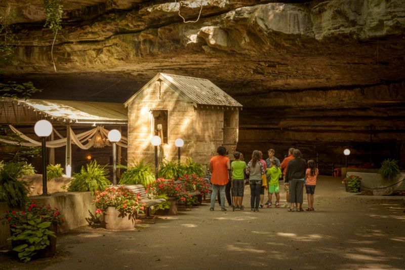 A group of people are walking through a cave.